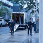 Moving Co. movers walking back to the truck on a downtown Toronto street