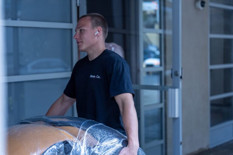 Moving Co. mover at the entrance of a building during a move