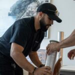 Moving Co. mover wrapping a chair in plastic in a condo