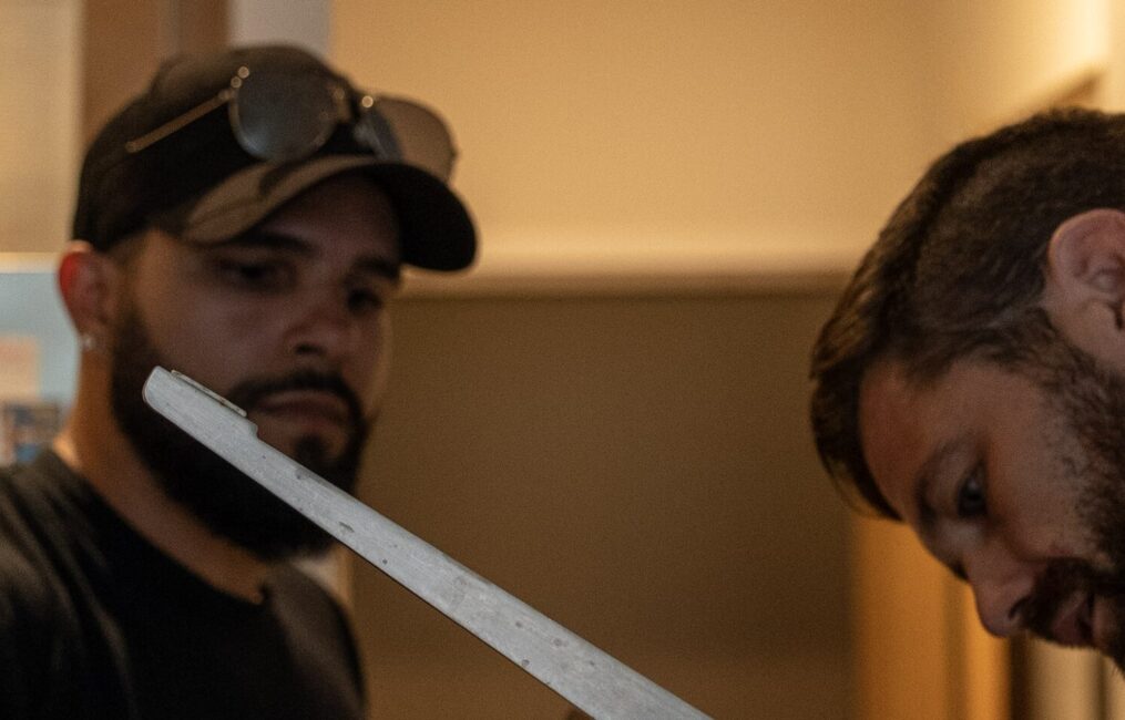 Two Moving Co. movers working on the metal base of a wrapped chair