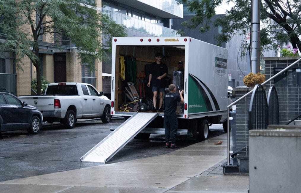Moving Co. truck parked with the ramp down on a downtown Toronto street
