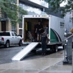 Moving Co. truck parked with the ramp down on a downtown Toronto street